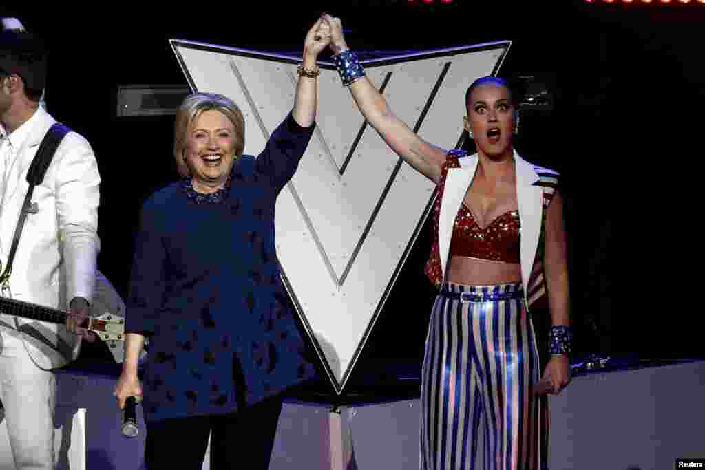Singer Katy Perry raises arms with U.S. Democratic presidential candidate Hillary Clinton at the end of the Hillary Victory Fund &quot;I&#39;m With Her&quot; benefit concert at Radio City Music Hall in the Manhattan borough of New York City, March 2, 2016.