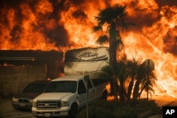 Flames consume a home on Via Arroyo as a wildfire rages in Ventura, Calif., on Tuesday, Dec. 5, 2017.