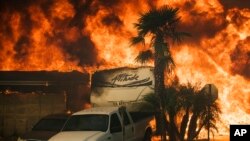 Flames consume a home on Via Arroyo as a wildfire rages in Ventura, Calif., on Tuesday, Dec. 5, 2017. 