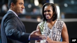 First Lady Michelle Obama on stage with actor Kal Penn at the Democratic National Convention inside Time Warner Cable Arena in Charlotte, N.C., on Monday, Sept. 3, 2012.