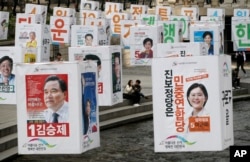 Election posters of candidates for Seoul's constituencies in parliamentary election are hung on string over the Cheonggye Stream in Seoul, South Korea, April 13, 2016.