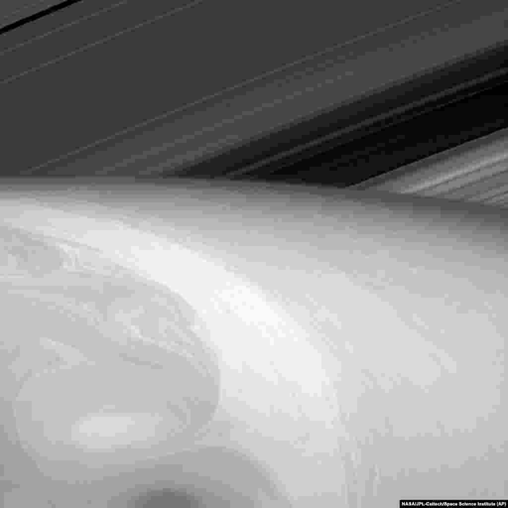 This Aug. 23, 2014 image made available by NASA shows the fluid dynamics in Saturn's uppermost cloud layers. 