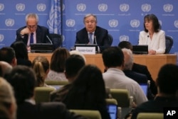 Secretary-General António Guterres, center, accompanied by U.N. spokesman Stéphane Dujarric, left, and Ninette Kelley, director of the U.N. High Commissioner for Refugees, speaks to U.N. correspondents on World Refugee Day at U.N. headquarters in New York.