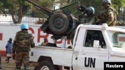 FILE - U.N. peacekeepers take a break as they patrol along a street during presidential elections in Bangui, the capital of the Central African Republic, Dec. 30, 2015. 