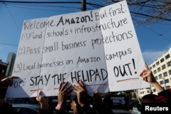 FILE - Demonstrators gather to protest Amazon's headquarters location in Long Island City of the Queens borough of New York, Nov. 14, 2018.