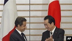 French President Nicolas Sarkozy is welcomed by Japanese Prime Minister Naoto Kan prior to their talks at Kan's official residence in Tokyo, March 31, 2011