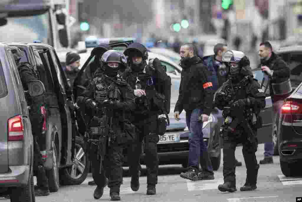 French police forces take position in the Neudorf district of Strasbourg, France. Security forces were trying to catch the suspected Strasbourg gunman dead or alive as the city was still in mourning with candles lit and flowers left at the site of Tuesday's attack near the Christmas market.