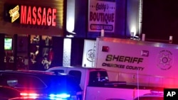 CORRECTS DATELINE TO ACWORTH INSTEAD OF WOODSTOCK - Authorities investigate a fatal shooting at a massage parlor, late Tuesday, March 16, 2021, in Acworth, Ga.
