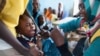 FILE - A child receives a meningitis vaccination at the community center in Al Neem camp for Internally Displaced People in El Daein, East Darfur, Oct. 8, 2012.