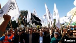 Les partisans d’Hizb Ut-Tahrir brandissent des drapeaux lors d’un rassemblement à Sidi Bouzid, Tunisie, 17 décembre 2013.