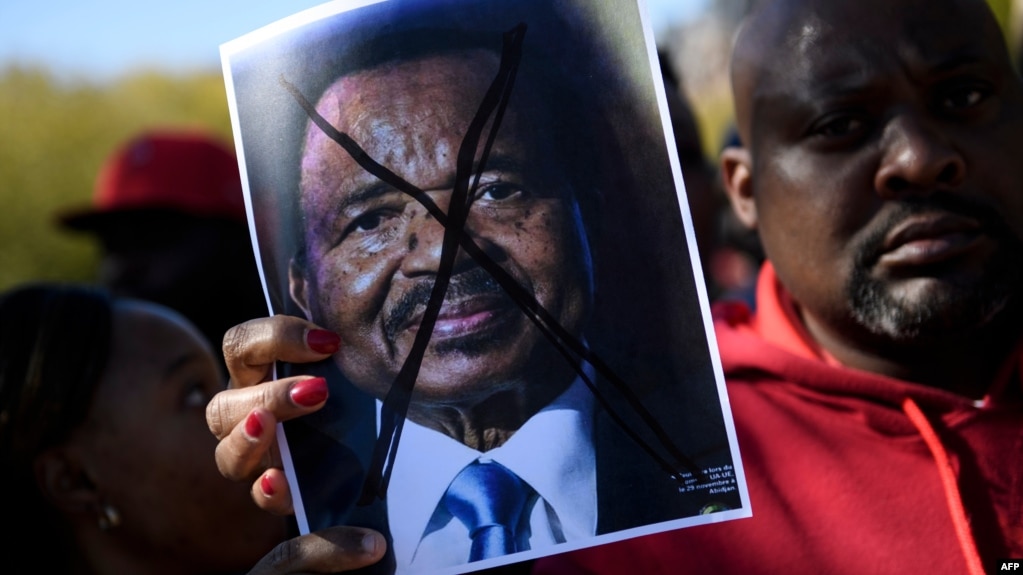 People protest Cameroon's President Paul Biya on Pennsylvania Avenue near the White House, Oct. 22, 2018 in Washington. On Saturday protesters marched and sang on the streets in Douala and other cities.