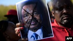 People protest Cameroon's President Paul Biya on Pennsylvania Avenue near the White House, Oct. 22, 2018 in Washington. On Saturday protesters marched and sang on the streets in Douala and other cities.