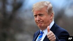 President Donald Trump gestures to the media as he leaves the White House, Friday, Feb. 16, 2018, in Washington, for a trip to his private Mar-a-Lago resort in Florida.