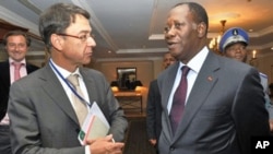 Ivory Coast's internationally recognized president Alassane Ouattara (R) chats with Koen Vervaeke, EU's Ambassador to the African Union during his meeting with around 30 diplomats on March 11, 2011 in Addis Ababa