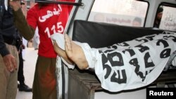 Ambulance workers load the body of Mashal Khan into an ambulance after a mob beat him to death at his university campus in Mardan, Pakistan, April 13, 2017.