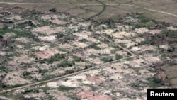 FILE - An aerial view shows burned down villages once inhabited by the Rohingya Muslims seen from the Myanmar military helicopters that carried the U.N. envoys to northern Rakhine state, Myanmar, May 1, 2018.