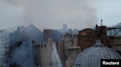 Firefighters attend to a blaze at the Mackintosh Building at the Glasgow School of Art for the second time in four years, Glasgow, Scotland, June 16, 2018.