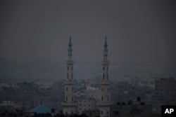 Monday marked the beginning of the three-day Eid al-Fitr holiday, which caps the Muslim fasting month of Ramadan. Minarets from a mosque are seen in this view of Gaza city, July 28, 2014.