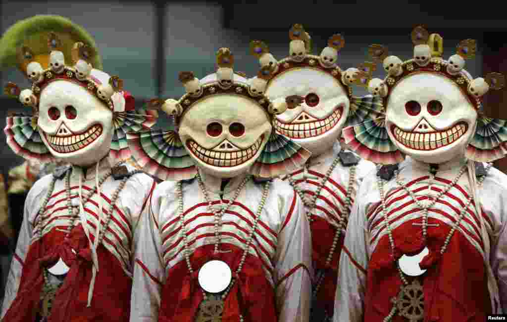 Monks dressed as Tibetan Buddhism characters attend a religious ceremony, known as "Da Gui" or beating ghost, to celebrate the upcoming Tibetan New Year in Beijing.