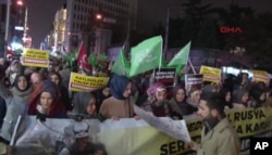 In this image from video, people march toward the Russian consulate in Istanbul to protest Russia's involvement in the Syrian government's push to retake rebel-held areas of the city of Aleppo, Dec. 13, 2016.