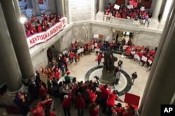 Hundreds of Kentucky teachers protest outside of Gov. Matt Bevin's office, March 30, 2018, in Frankfort, Ky. State lawmakers passed a bill late Thursday night that makes changes to the state's pension system.