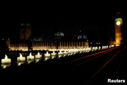Candles burn on Westminster Bridge the day after an attack in London, March 23, 2017.