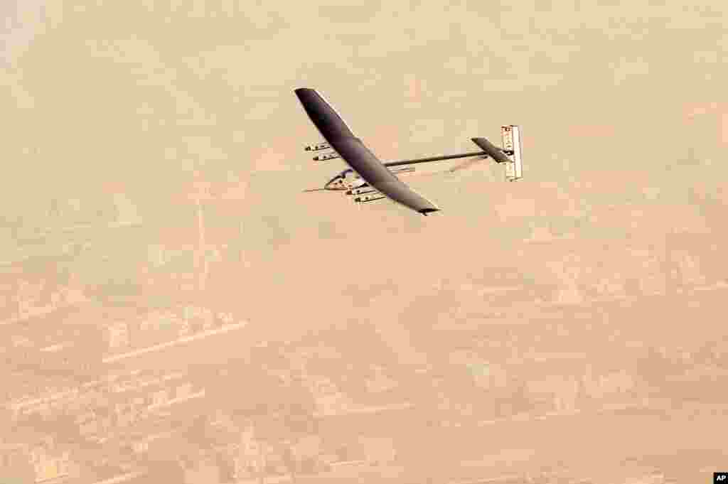 In this photo released by Solar Impulse, &quot;Solar Impulse 2&quot;, a solar-powered airplane flies after taking off from Al Bateen Executive Airport in Abu Dhabi, United Arab Emirates, marking the start of the first attempt to fly around the world without a drop of fuel.