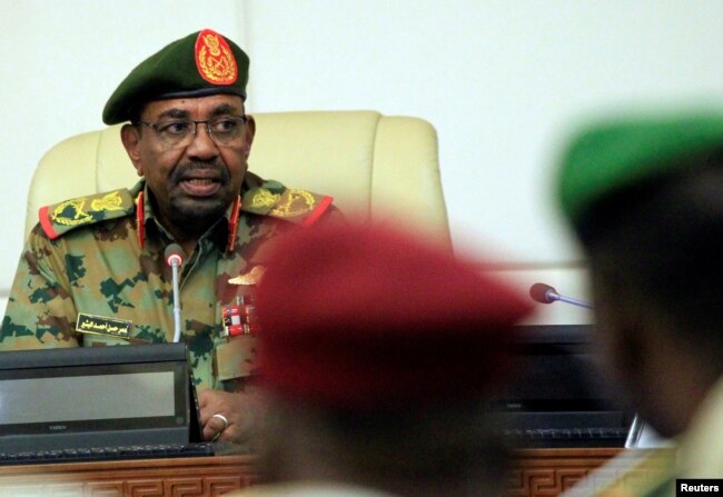 FILE - Sudan's President Omar al-Bashir is seen during a swearing-in ceremony of new officials after he dissolved the central and state governments in Khartoum, Sudan, Feb. 24, 2019.