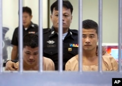 Myanmar migrants Win Zaw Htun, right, and Zaw Lin, left, both 22, are escorted by officials after their guilty verdict at court in Koh Samui, Thailand, Thursday, Dec. 24, 2015.