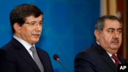 Turkish Foreign Minister Ahmet Davutoglu, left, speaks as his Iraqi counterpart Hoshyar Zebari, listens during a joint press conference in Baghdad, Iraq, Sunday, Nov. 10, 2013