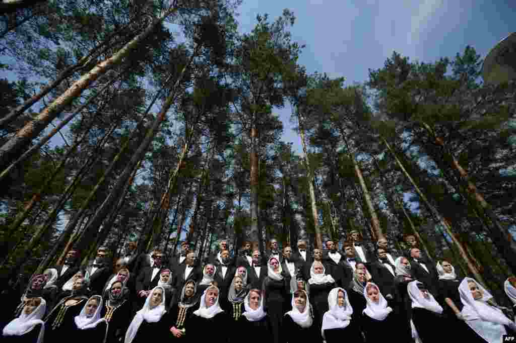 A Belarus' choir attends a ceremony for the unveiling of the monument to the victims of World War Two (WWII) on the grounds of the former Nazi concentration camp in Trostenets outside Minsk.