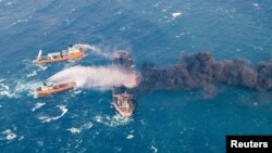 Rescue ships work to extinguish the fire on the Panama-registered Sanchi tanker carrying Iranian oil, which caught fire after a collision with a Chinese freight ship in the East China Sea, in this Jan. 10, 2018, photo provided by China's Ministry of Transport and released by China Daily.