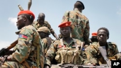 FILE - A group of South Sudanese government soldiers sit on the back of a pickup truck in Malakal, South Sudan, Oct. 16, 2016. Angelina Teny, wife of South Sudan rebel leader Riek Machar says, the “politics of isolation” are working against the interest of peace in her country.