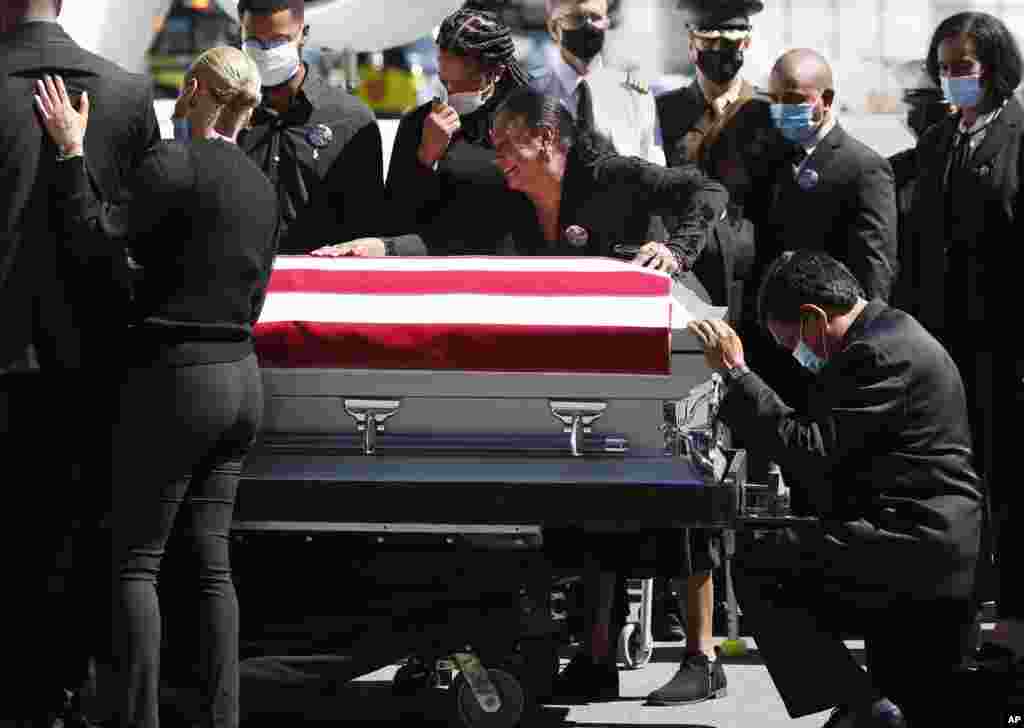 Family members of U.S. Marine Sgt. Johanny Rosario Pichardo grieve upon the arrival of his casket at Logan Airport in Boston, Sept. 11, 2021. Rosario Pichardo died in the Aug. 26 suicide bombing near the Kabul airport where people were being evacuated amid the Taliban takeover of Afghanistan.