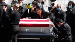 FILE - Family members of U.S. Marine Sgt. Johanny Rosario Pichardo are grief stricken upon the arrival of his casket at Logan Airport in Boston.