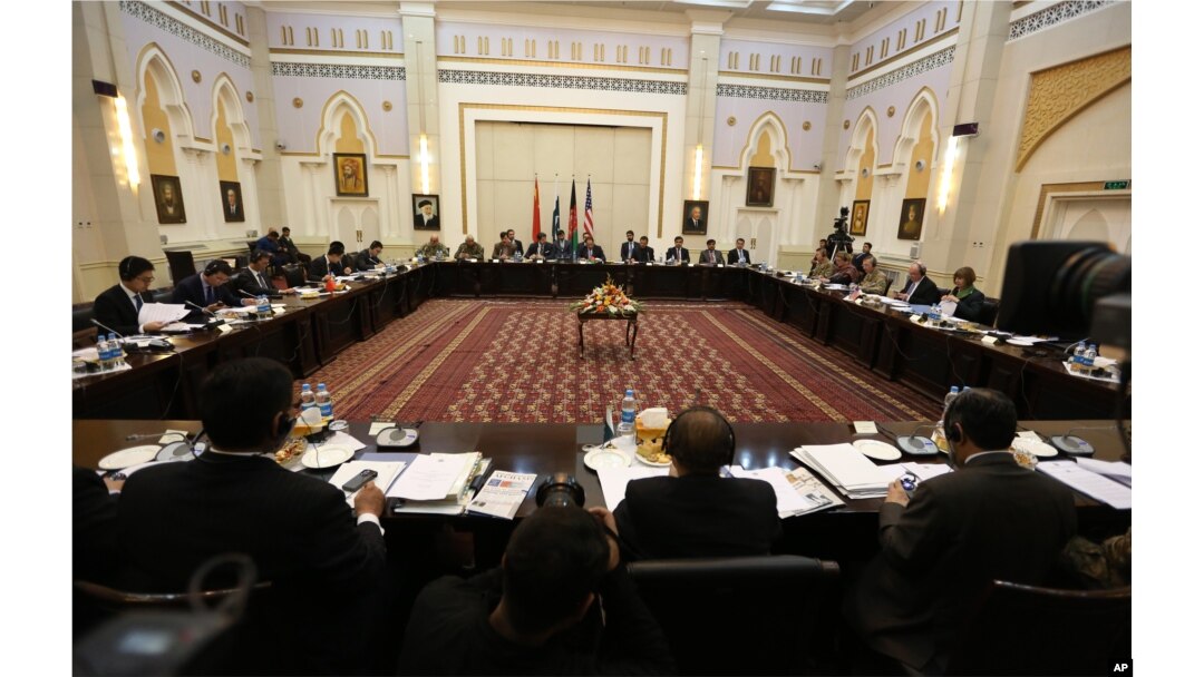 FILE - Delegations from Afghanistan, Pakistan, the United States and China discuss a road map for ending the war with the Taliban at the Presidential Palace in Kabul, Afghanistan, Feb. 23, 2016.
