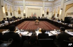 FILE - Delegations from Afghanistan, Pakistan, the United States and China discuss a road map for ending the war with the Taliban at the Presidential Palace in Kabul, Afghanistan, Feb. 23, 2016.