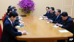 In this photo provided by South Korea Presidential Blue House via Yonhap News Agency, Kim Yong Chol, vice chairman of North Korea's ruling Workers' Party Central Committee, second from right, talks with South Korean delegation in Pyongyang, North Korea.