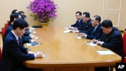 In this photo provided by South Korea Presidential Blue House via Yonhap News Agency, Kim Yong Chol, vice chairman of North Korea's ruling Workers' Party Central Committee, second from right, talks with South Korean delegation in Pyongyang, North Korea, M