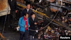 FILE - South Korean President Park Geun-hye visits the scene of a fire at a traditional market in Daegu, South Korea, Dec. 1, 2016.
