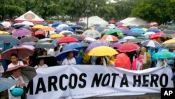 Protesters display a banner as they gather for a rally at Rizal Park in Manila to oppose the burial of the late Philippine dictator Ferdinand Marcos at the Heroes' Cemetery, Aug. 14, 2016.