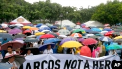 Protesters display a banner as they gather for a rally at Rizal Park in Manila to oppose the burial of the late Philippine dictator Ferdinand Marcos at the Heroes' Cemetery, Aug. 14, 2016.