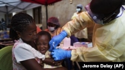 In this Saturday, July 13, 2019 photo, a child is vaccinated against Ebola in Beni, Congo. But after nearly a year and some 171,000 doses given, the epidemic shows few signs of waning. (AP Photo/Jerome Delay)