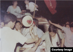 Meishi, center, holding a megaophone, is seen during pro-democracy protests in Beijing, June 2, 1989.
