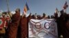 Buddhist monks hold a banner as they protest against the opening of Organization of Islamic Cooperation (OIC) offices in Burma, in front of the city hall in Rangoon, October 15, 2012. 