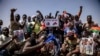 FILE - People take to the streets of Ouagadougou, Burkina Faso, Jan. 25, 2022 to rally in support of the new military junta that ousted democratically elected President Roch Marc Christian Kabore and seized control of the country. 