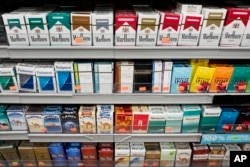 Cigarettes are displayed on a shelf in New York, Aug. 28, 2017.