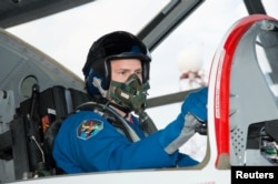 FILE - Astronaut Nick Hague prepares for a flight in a T-38 jet as part of astronaut training at Ellington Field Joint Reserve Base in Houston, Texas, April 18, 2014.