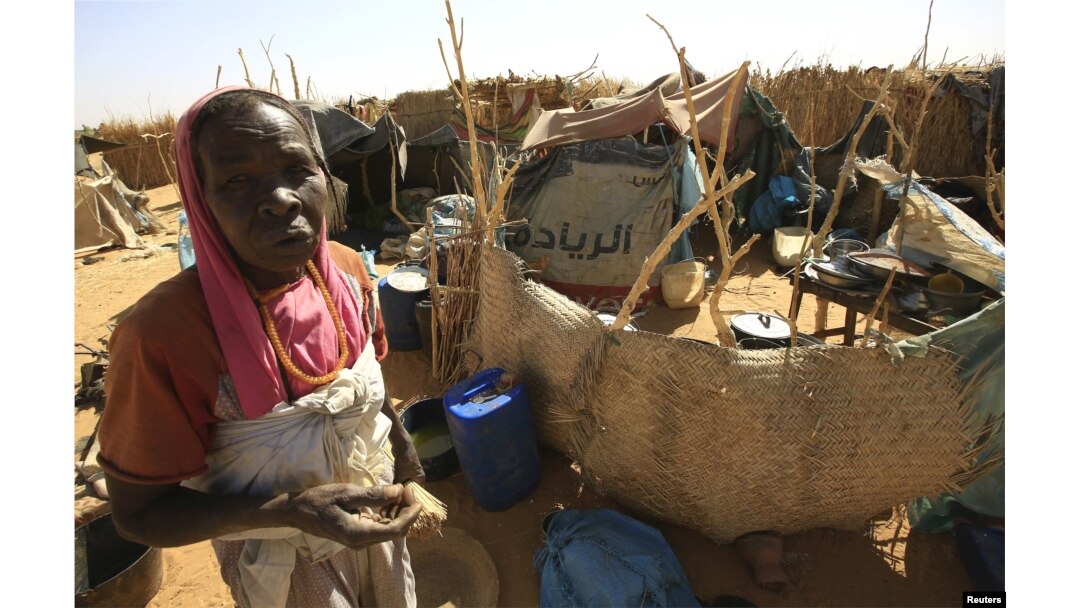 FILE - A woman looks on beside a shelter after arriving at the Zam Zam IDP camp, near Al Fashir in North Darfur, Sudan, April 9, 2015.