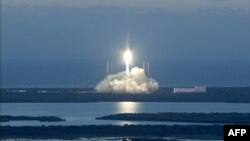 FILE - This NASA handout file photo taken Feb. 11, 2015, shows NOAA's DSCOVR satellite launching from Cape Canaveral Air Force Station in Florida. A chunk of a SpaceX rocket that blasted off seven years ago will crash into the moon in March, experts say. 